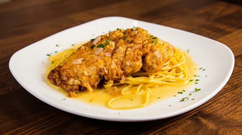 Chicken piccata with capers and parsley over linguine pasta in a lemon butter sauce.